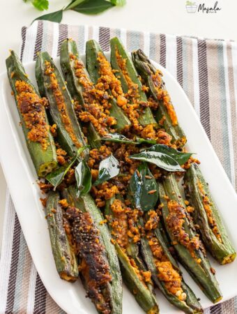 Stuffed Okra Recipe- stuffed bhindi served on a white plate.