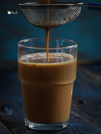 Straining masala tea through a tea strainer.