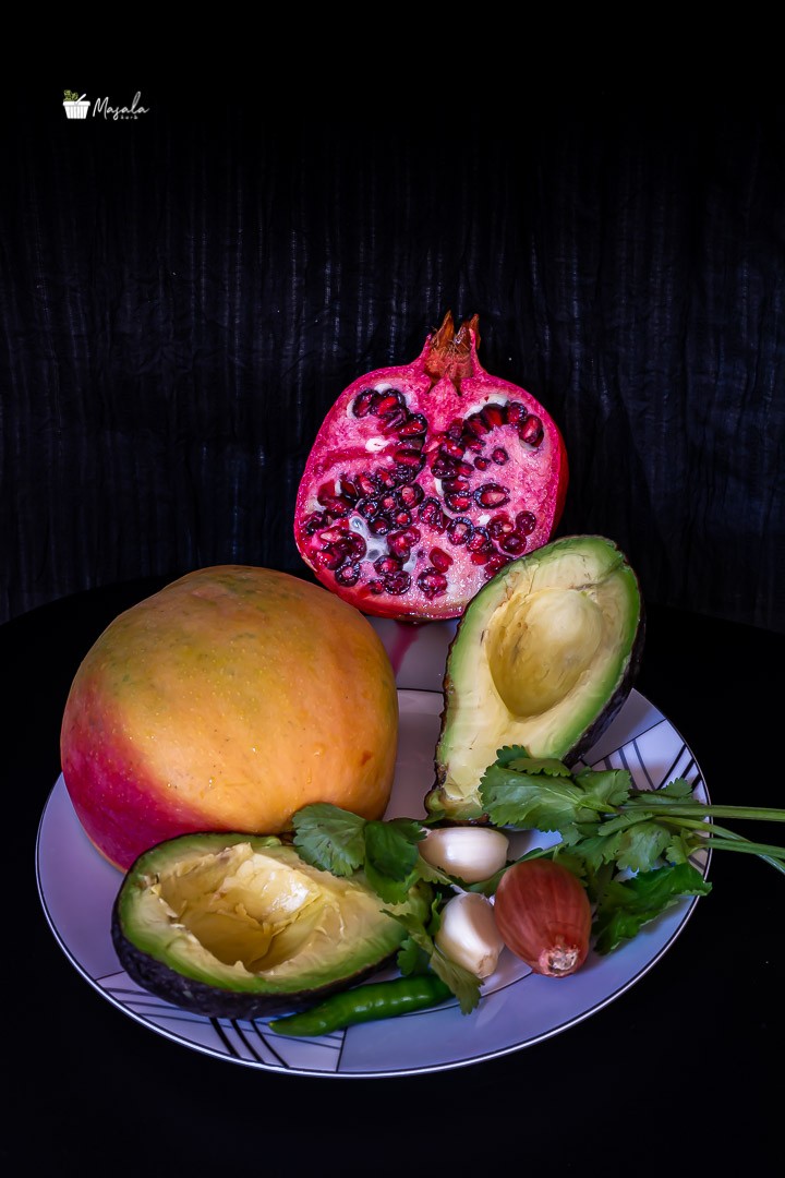 Ingredients display of mango pomegranate guacamole.