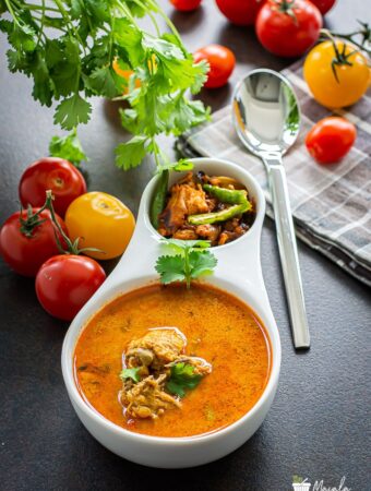 Chicken Rasam, Indian Chicken Soup served in a bowl.