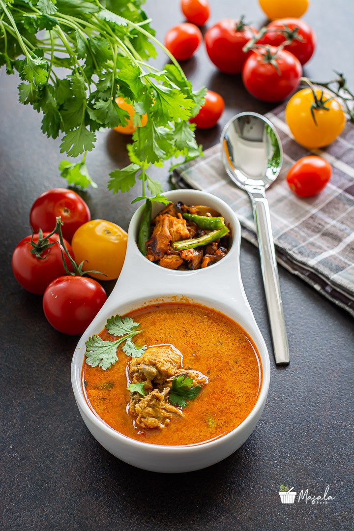 Chicken Rasam or Indian Style Chicken Soup with chicken fry served in a bowl.