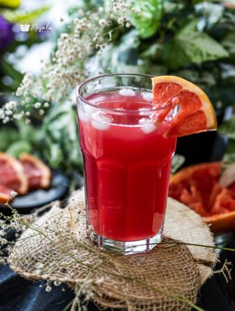 Sea breeze mocktail served with a grapefruit wedge.