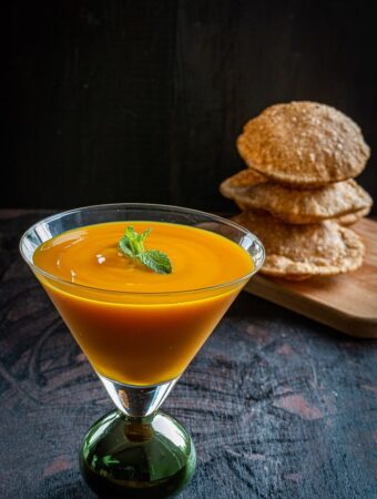 Aamras Puri served in a tall glass along with puris.