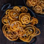 Instant Jalebi Recipe Without Yeast sprinkled with some shaved almonds.