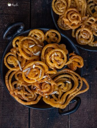 Instant Jalebi Recipe Without Yeast sprinkled with some shaved almonds.