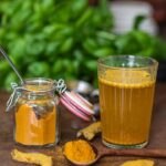 Turmeric tea powder recipe with turmeric tea in a glass