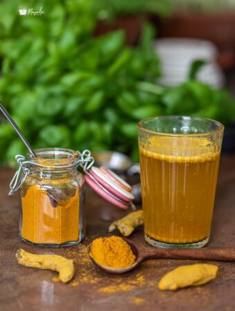 Turmeric tea powder recipe with turmeric tea in a glass