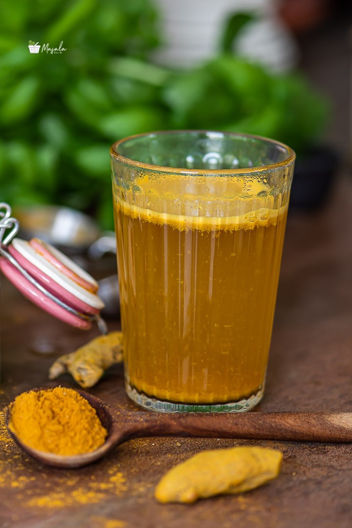 Haldi tea for weight loss served in a glass.