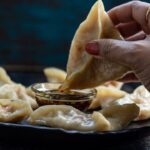 Steamed momos served with a chilli garlic sauce.