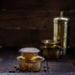 South Indian filter coffee seved in a brass dabarah and tumbler