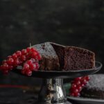 Eggless Chocolate Cake Recipe making and cke on a stand.