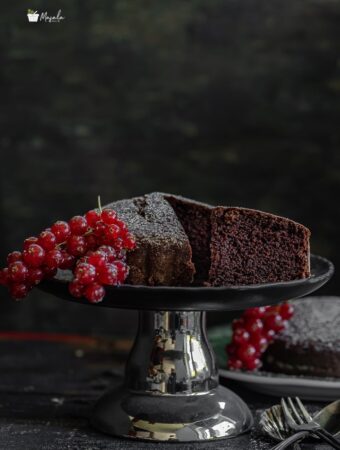 Eggless Chocolate Cake Recipe making and cke on a stand.