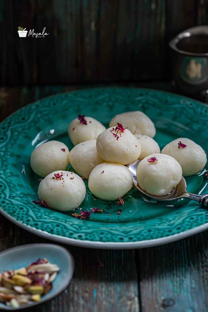 Chena Rasgulla served on a teal plate