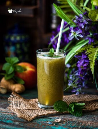 Apple Ginger Mint Juice served in a tall glass.