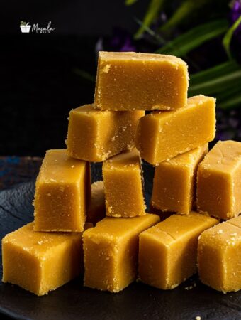 Close up view of a stack of sreee krishna sweet mysore pak