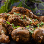 Lemon pepper chicken indian style served on a black plate