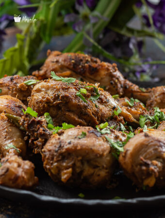 Lemon pepper chicken indian style served on a black plate