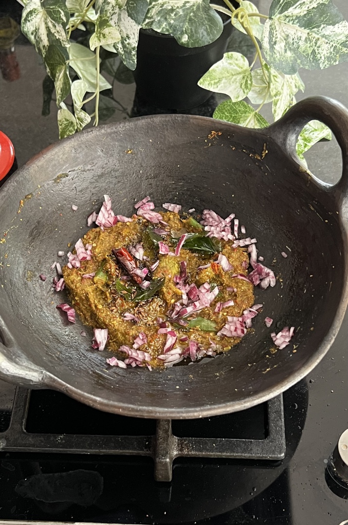 Chukka kura Pachadi with onions served in a black mud pan.
